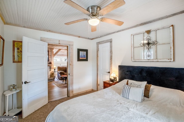 bedroom with ceiling fan and ornamental molding