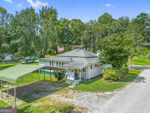 exterior space featuring a carport, a porch, and a front lawn