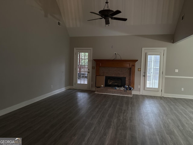 unfurnished living room with a fireplace, high vaulted ceiling, dark hardwood / wood-style floors, and ceiling fan