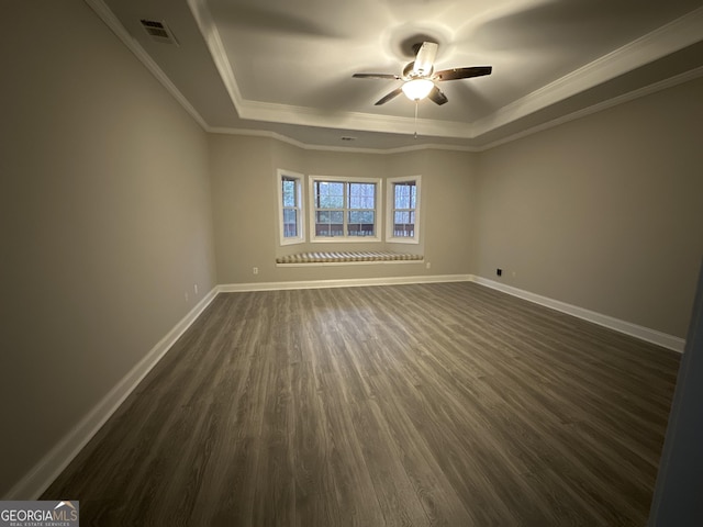 spare room with crown molding, ceiling fan, dark hardwood / wood-style floors, and a raised ceiling