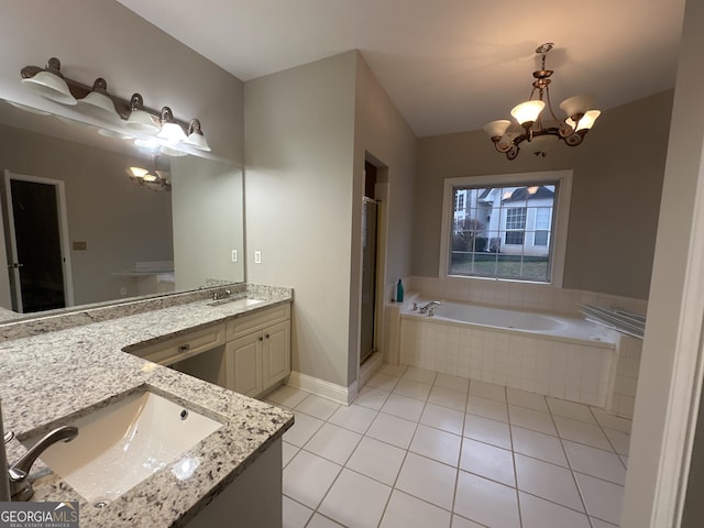 bathroom featuring tile patterned flooring, vanity, a chandelier, and plus walk in shower