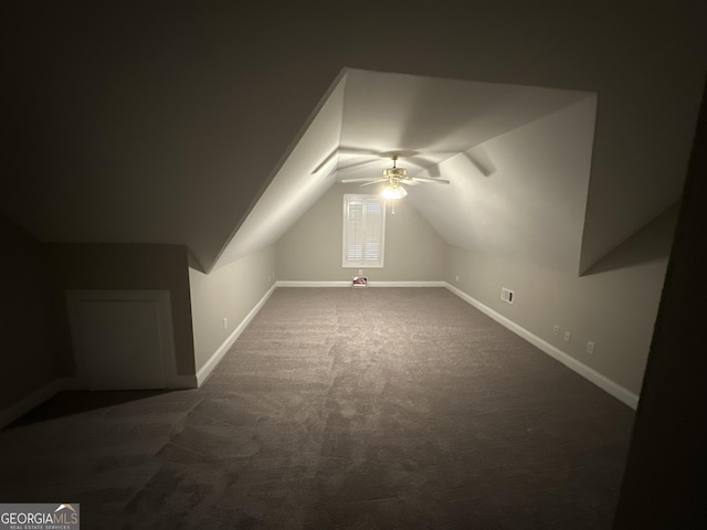 bonus room with dark colored carpet, vaulted ceiling, and ceiling fan