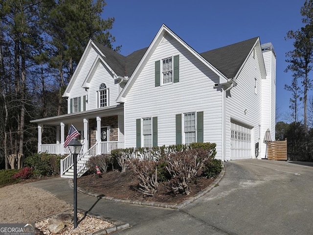 view of front facade featuring a porch and a garage