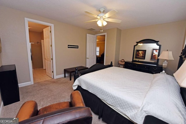 carpeted bedroom with ceiling fan and ensuite bathroom