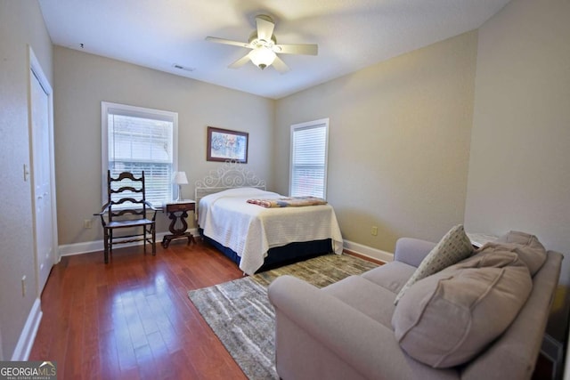 bedroom with ceiling fan and dark hardwood / wood-style floors