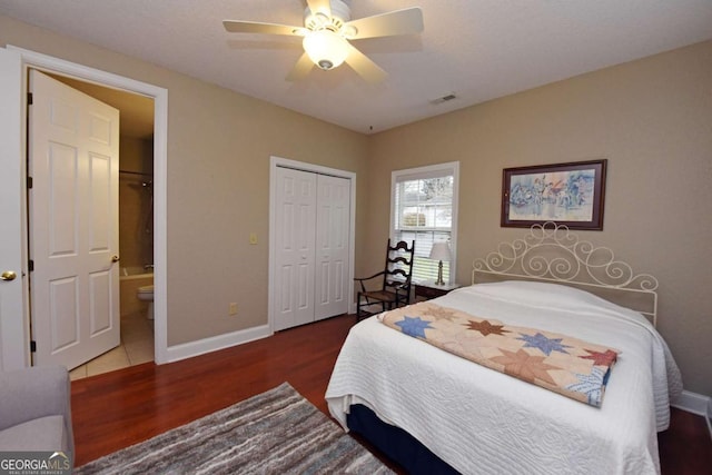 bedroom with dark hardwood / wood-style flooring, a closet, ceiling fan, and ensuite bathroom