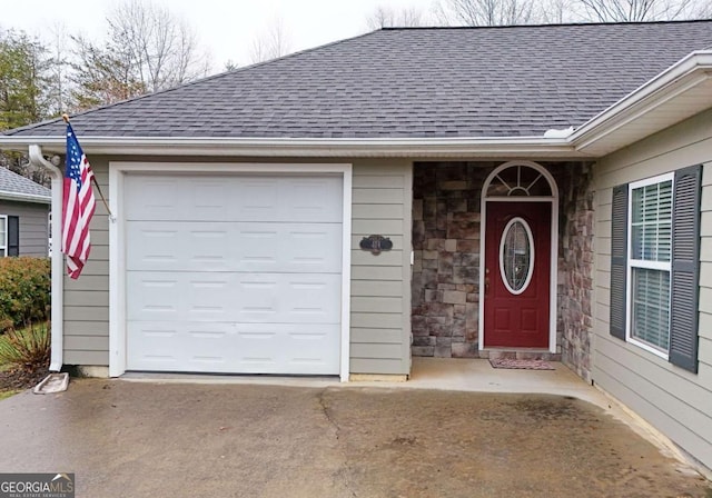 doorway to property with a garage