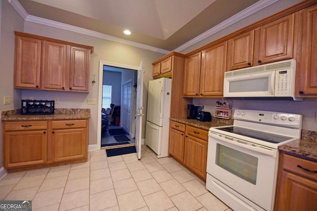 kitchen featuring lofted ceiling, dark stone countertops, light tile patterned floors, crown molding, and white appliances