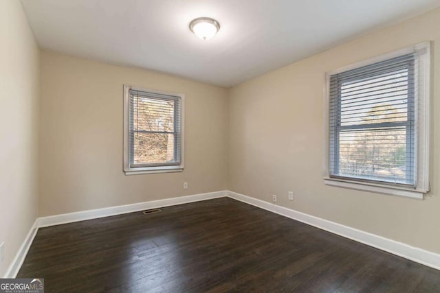 empty room featuring dark hardwood / wood-style floors