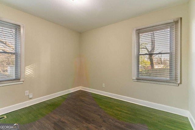 spare room featuring dark wood-type flooring