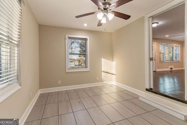 unfurnished room featuring plenty of natural light and ceiling fan