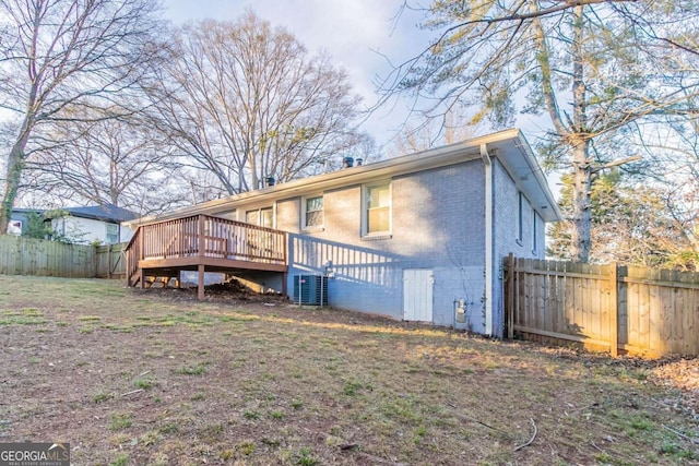 back of property with cooling unit and a deck