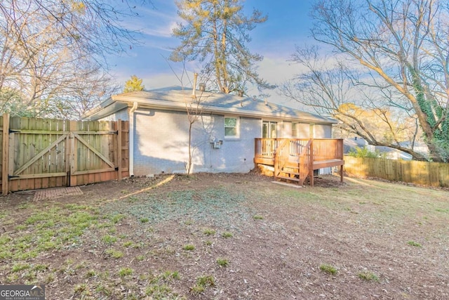 rear view of house featuring a deck