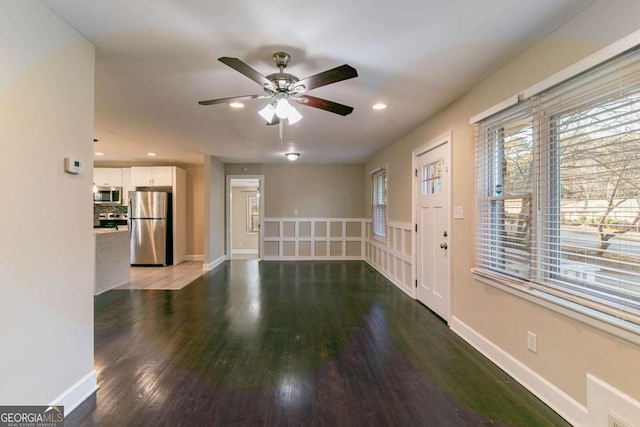 interior space with wood-type flooring and ceiling fan