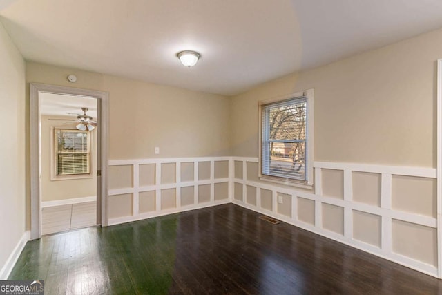 unfurnished room with dark hardwood / wood-style floors