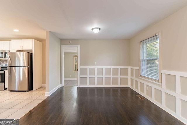 kitchen featuring white cabinetry, light wood-type flooring, and appliances with stainless steel finishes