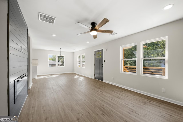 unfurnished living room featuring hardwood / wood-style flooring and ceiling fan