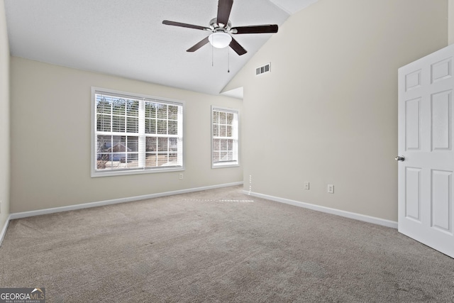 empty room featuring light carpet, high vaulted ceiling, and ceiling fan