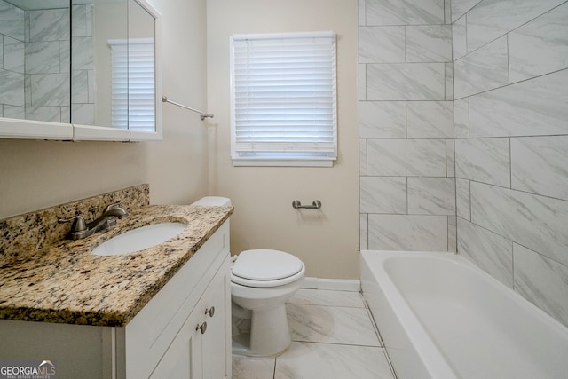 full bathroom featuring tiled shower / bath, vanity, and toilet