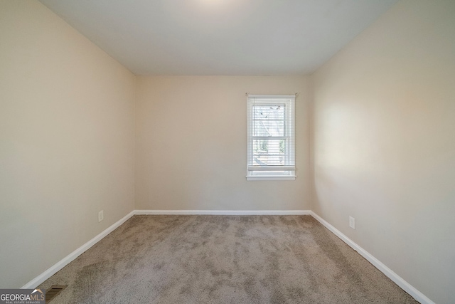 empty room featuring light carpet