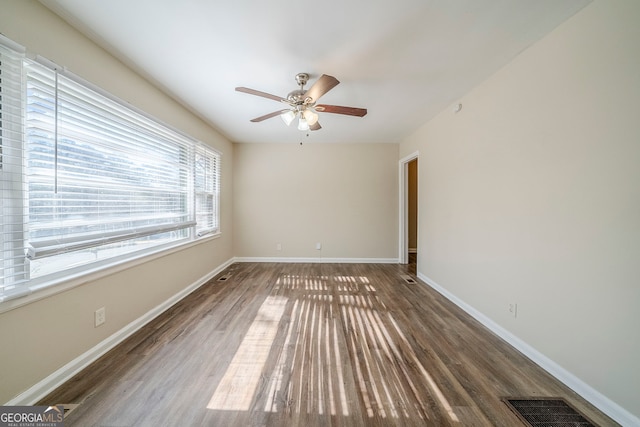 unfurnished room with ceiling fan and dark hardwood / wood-style floors