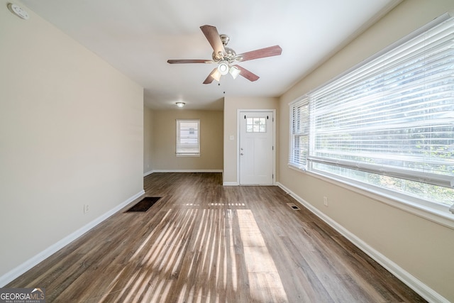 foyer entrance with wood-type flooring and ceiling fan