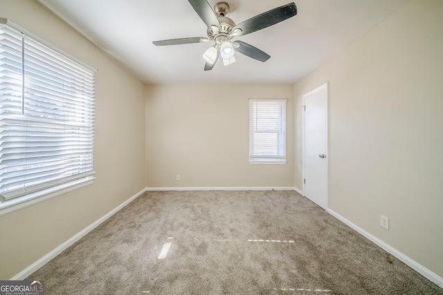 spare room with light colored carpet and ceiling fan