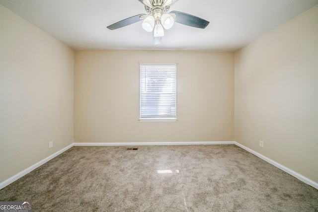 carpeted spare room featuring ceiling fan