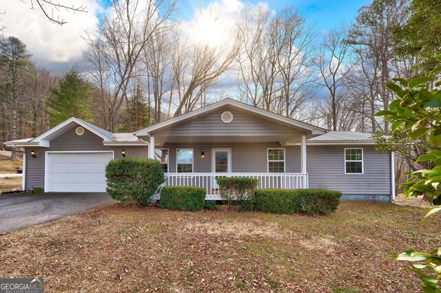 single story home with a porch and a garage