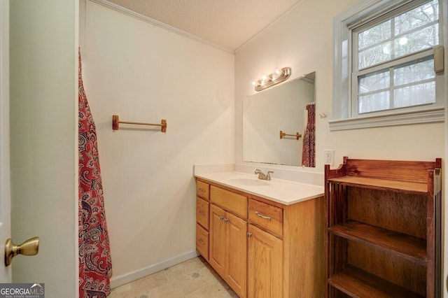 bathroom with vanity, ornamental molding, and a textured ceiling