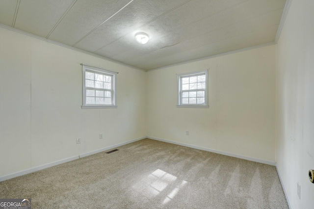 empty room with light colored carpet and ornamental molding