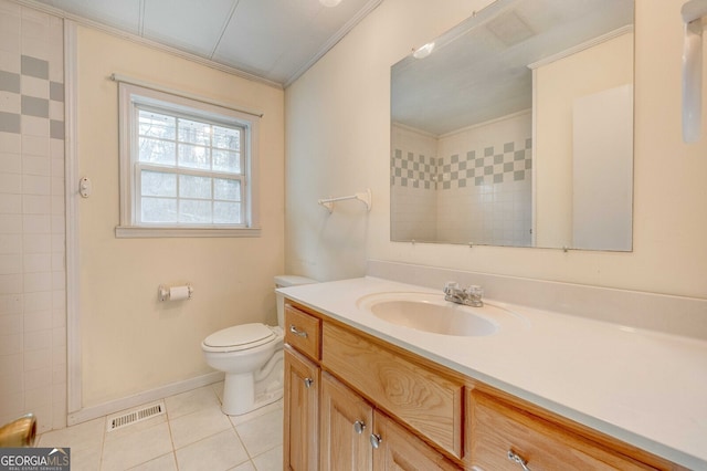 bathroom featuring tile patterned flooring, vanity, crown molding, and toilet