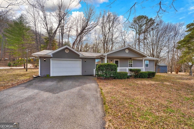 single story home featuring a garage and a porch