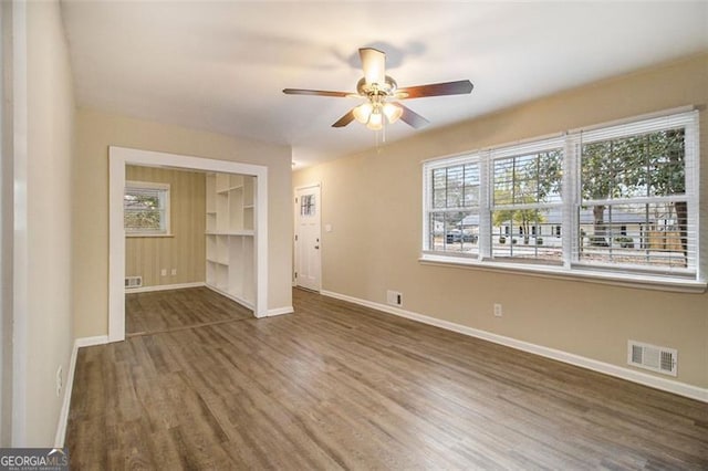 spare room with dark hardwood / wood-style floors and ceiling fan