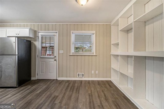 kitchen featuring white cabinetry, stainless steel fridge, ornamental molding, and dark hardwood / wood-style floors