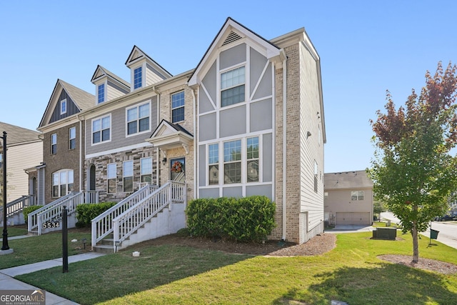 multi unit property featuring brick siding and a front lawn