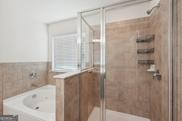 full bath featuring a garden tub and a shower stall