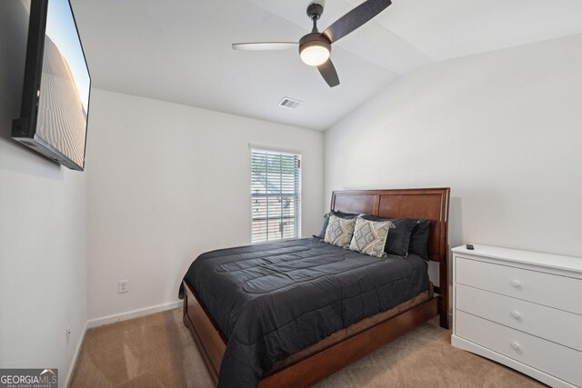 carpeted bedroom with vaulted ceiling and ceiling fan