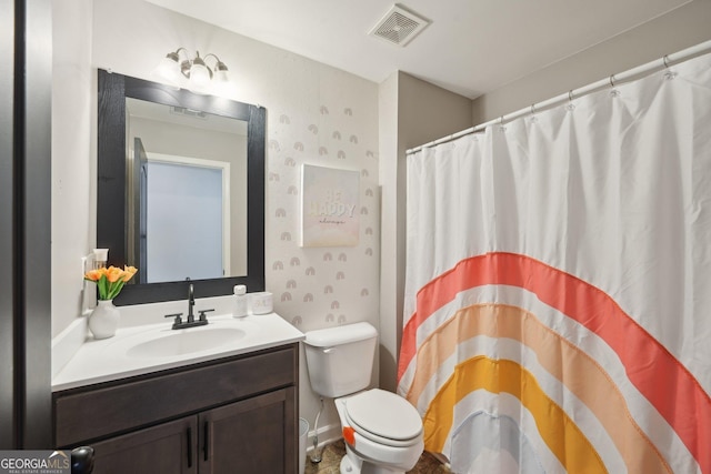 bathroom featuring vanity, toilet, and a shower with shower curtain