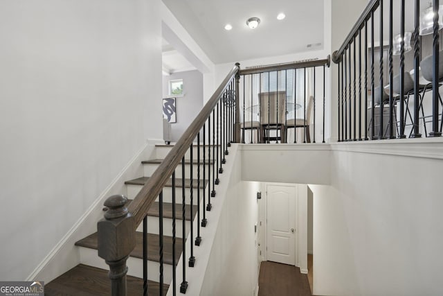 staircase featuring visible vents, baseboards, wood finished floors, and recessed lighting