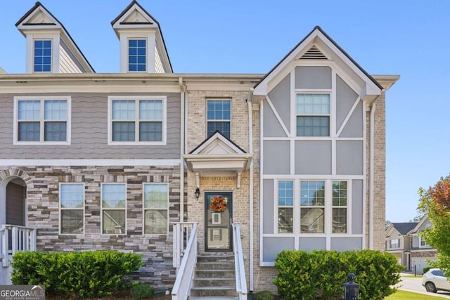 multi unit property featuring stone siding and brick siding