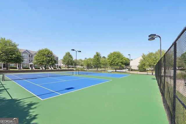 view of tennis court with fence