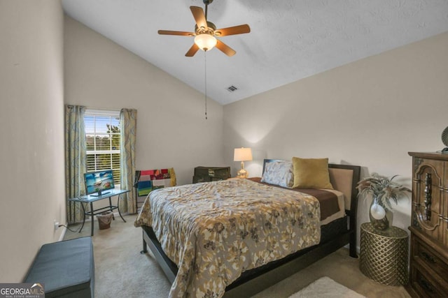 bedroom with ceiling fan, high vaulted ceiling, light carpet, and a textured ceiling