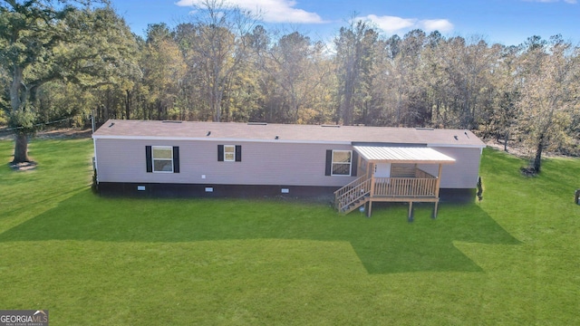 back of property featuring a yard and a deck