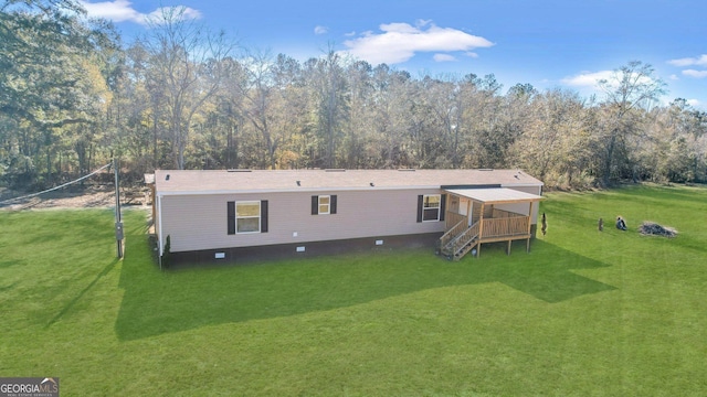 rear view of house with a yard