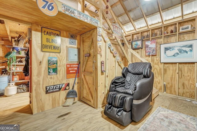 living area featuring wood walls