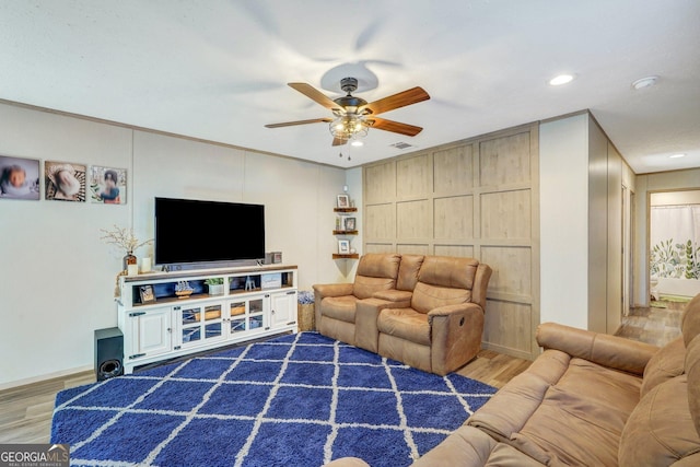 living room featuring ornamental molding, dark hardwood / wood-style floors, and ceiling fan