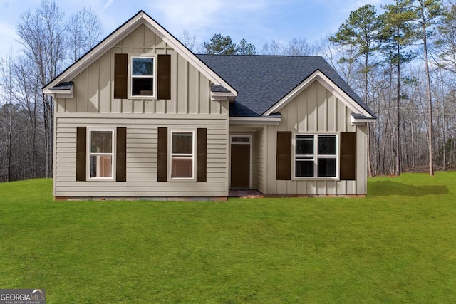 rear view of property featuring a lawn