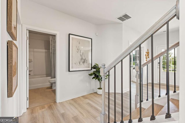 stairs with hardwood / wood-style flooring