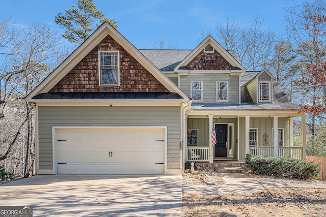 craftsman-style home with covered porch, driveway, and a shingled roof